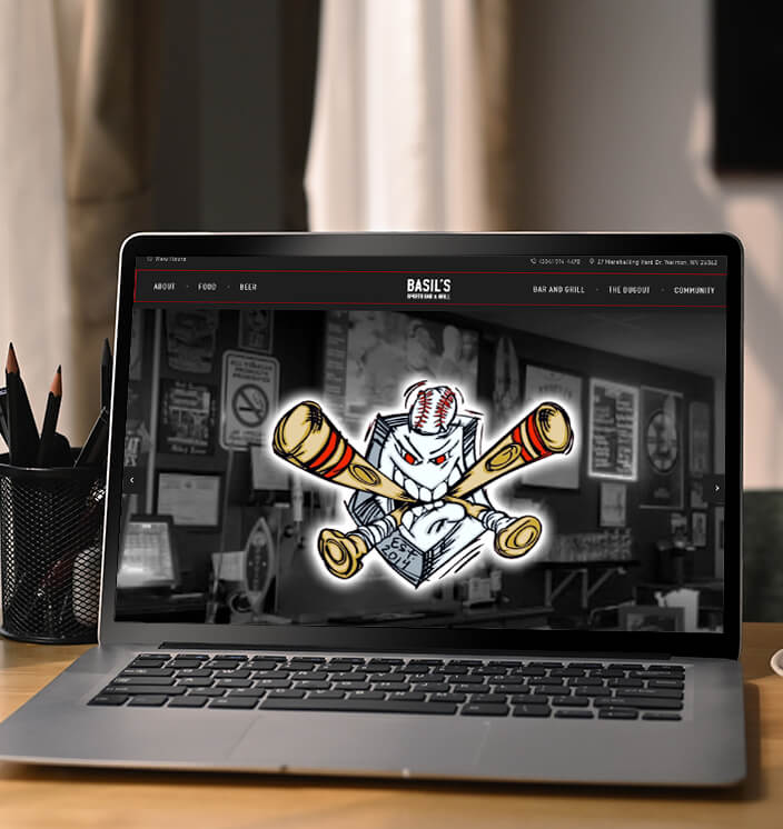 Basil's Sports Bar Website on Laptop